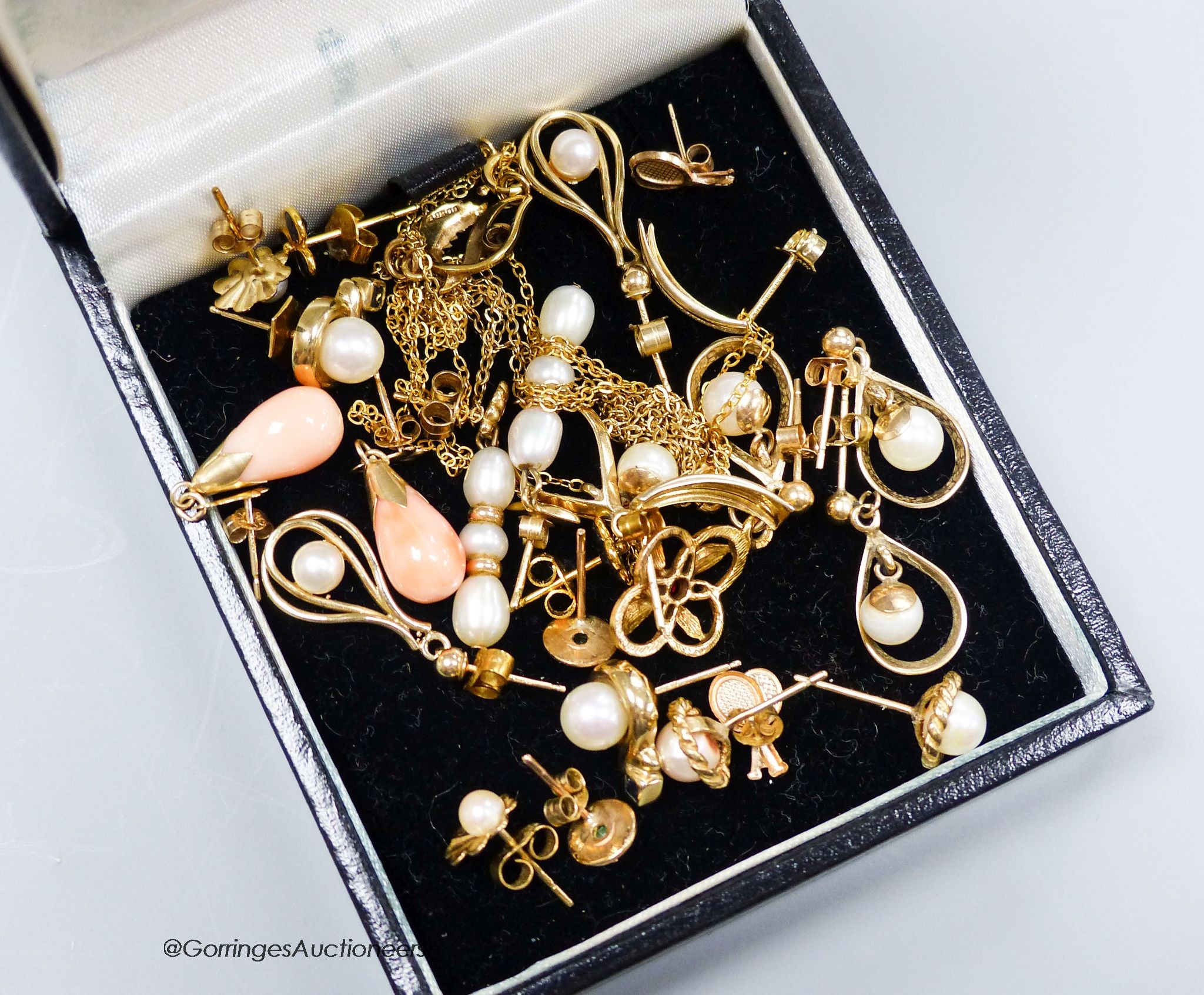 Twelve pairs of yellow metal earrings and two similar pendants, gross 19g.